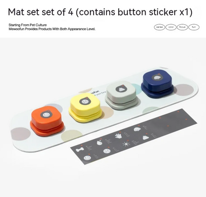Set of four pet communication buttons in orange, yellow, gray, and blue, mounted on a white mat with playful patterns.