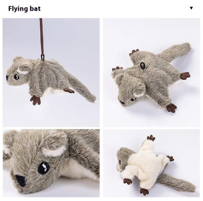 Plush toy resembling a flying bat, featuring soft gray fur, large eyes, and a white underside with brown paws.