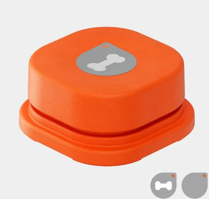 Orange pet communication button with a bone logo on top, designed for interactive use with pets.