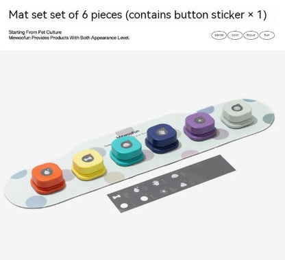Colorful Pet Communication Buttons arranged on a white mat, featuring orange, yellow, green, blue, purple, and gray buttons.