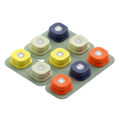 Eight colorful pet communication buttons arranged on a gray base, featuring yellow, orange, blue, and beige designs with symbols.